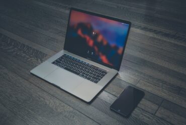 Laptop i telefon położone na biurku